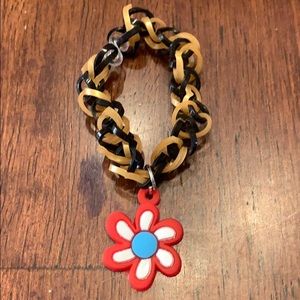 Rubber band bracelet with charm.